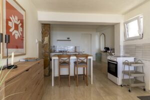 Open kitchen and dining island with two chairs at Studio Belma Croatia
