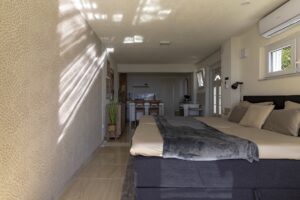 Bedroom interior with double bed and kitchen view in Studio Belma Brela