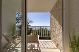 Balcony view from bedroom with chairs overlooking the Adriatic Sea