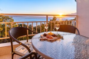 Sea view balcony at sunset with wine and charcuterie in Studio Brent Brela